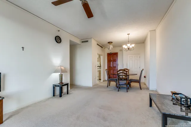 a view of a livingroom with furniture and a kitchen