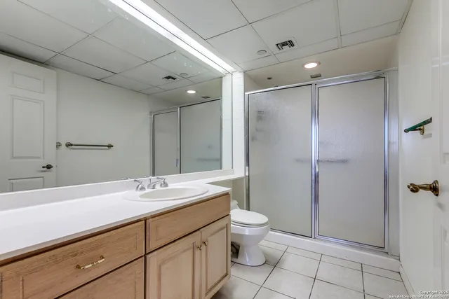 a bathroom with a double vanity sink toilet and shower
