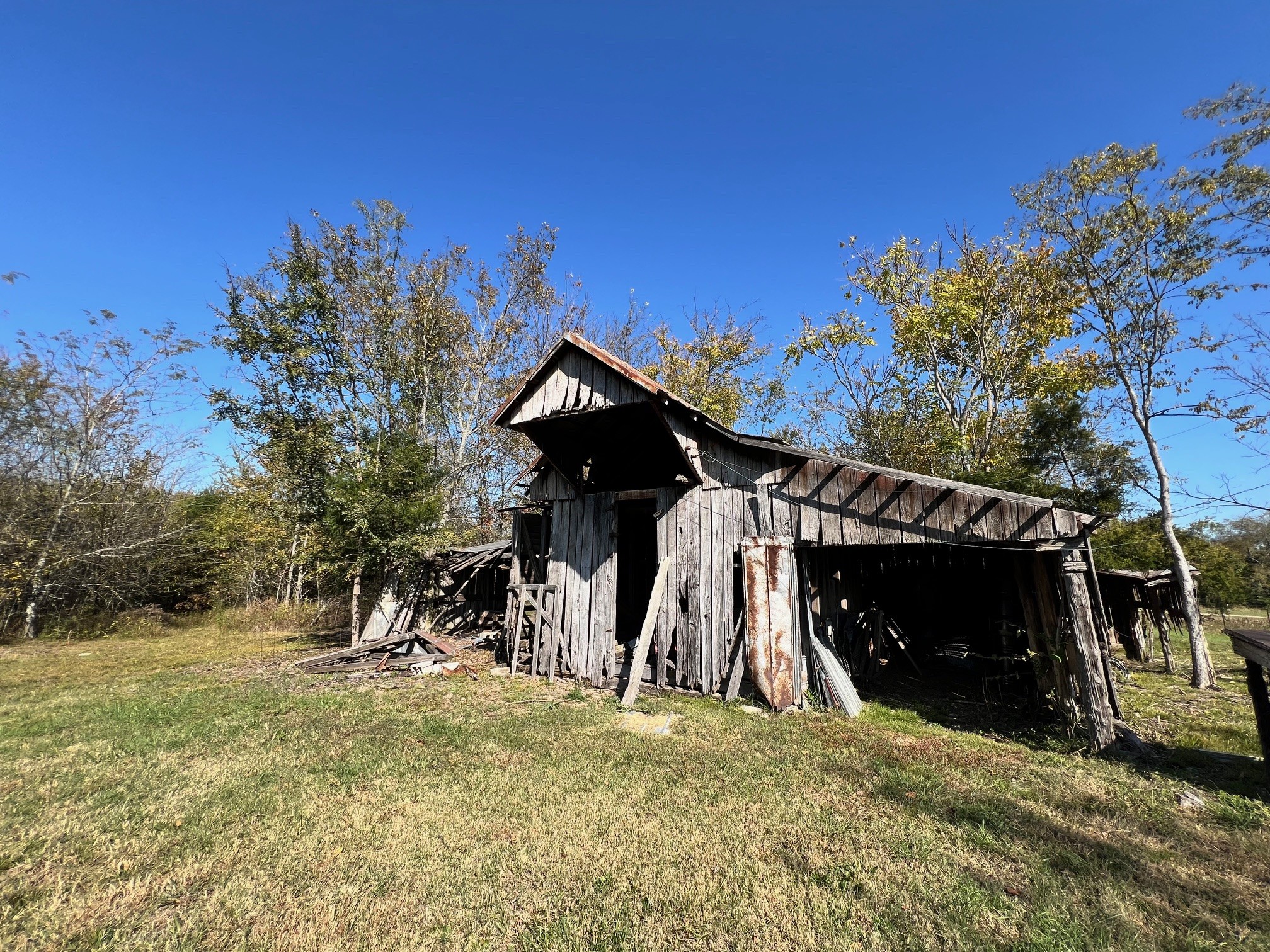 55 Bluebird Rd Extension Lebanon, TN 37087 - Photo 22 of 23 Older wooden barn on back right of property. Well in front of barn has been inspected and needs a new pump and to be cleaned out. PUBLIC water supply is at the road.