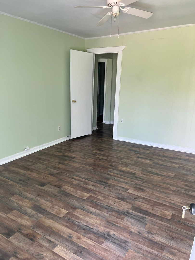 527 West 8th Street Freeport, TX 77541 - Photo 3 of 10 a view of an empty room with wooden floor