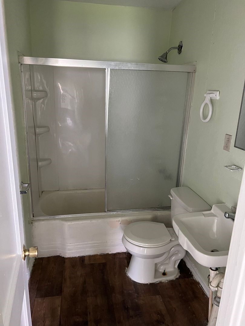 527 West 8th Street Freeport, TX 77541 - Photo 6 of 10 a bathroom with a toilet and a shower