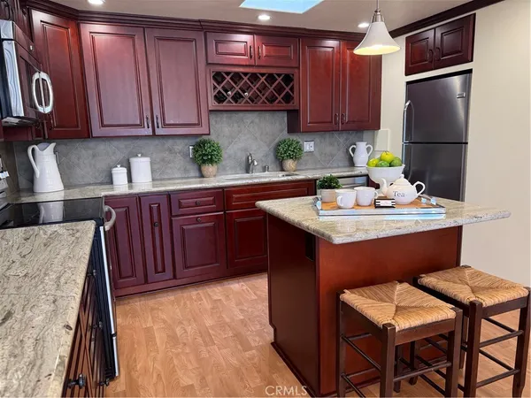 a bathroom with a granite countertop sink a mirror and a shower