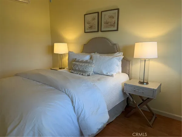 a bedroom with a bed and a mirror