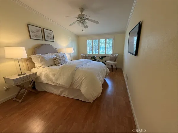 a bedroom with a bed and a painting on the wall