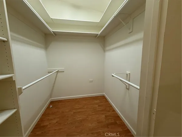 a bedroom with a bed and a lamp
