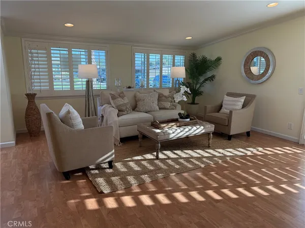 a dining room with furniture and wooden floor