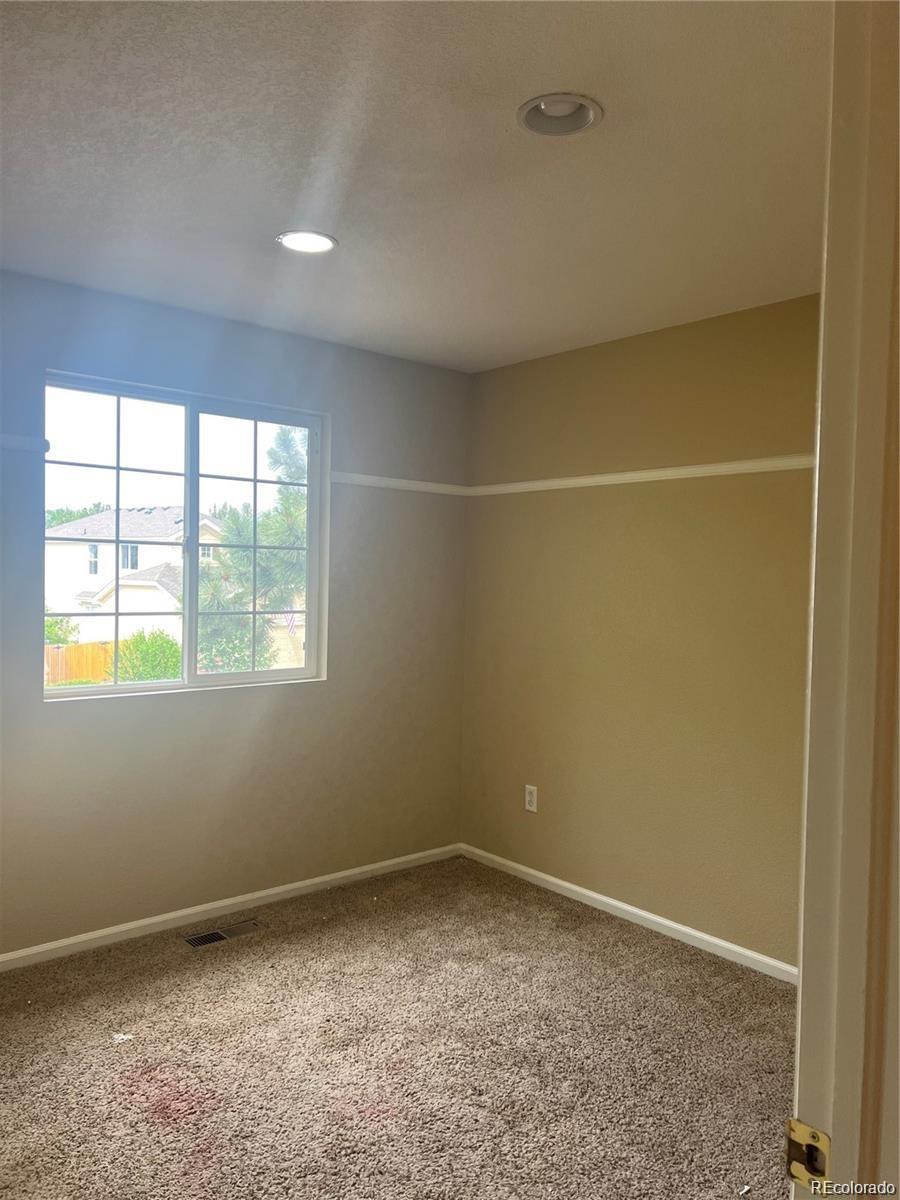 5353 Rhyolite Way Parker, CO 80134 - Photo 12 of 22 an empty room with a empty space and windows