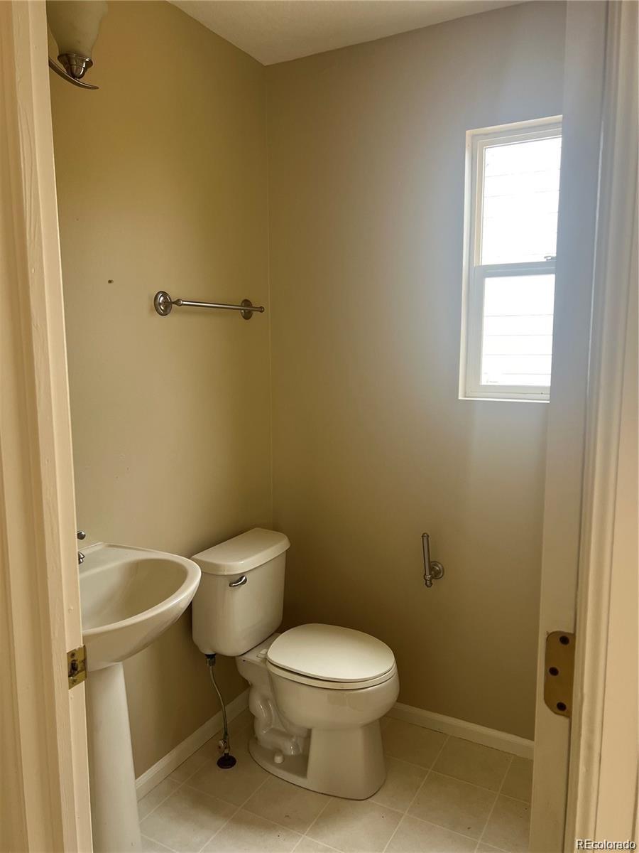 5353 Rhyolite Way Parker, CO 80134 - Photo 13 of 22 a white toilet sitting next to a bathroom sink