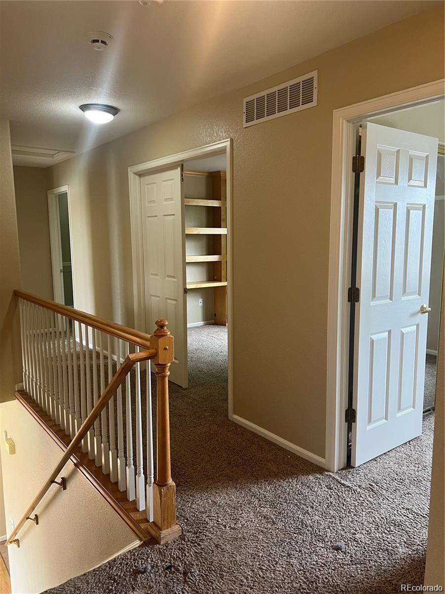 5353 Rhyolite Way Parker, CO 80134 - Photo 14 of 22 a view of entryway with stairs and wooden floor