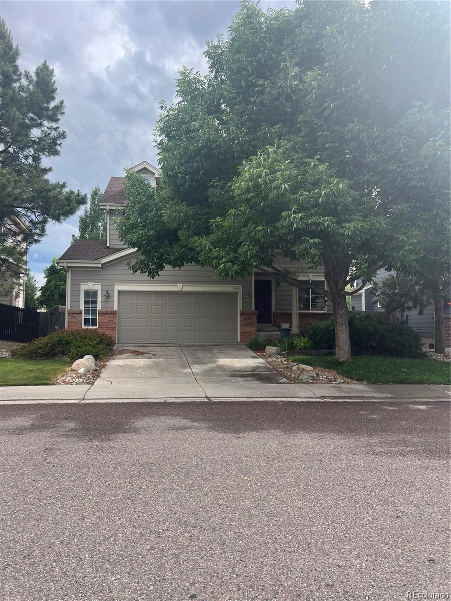 5353 Rhyolite Way Parker, CO 80134 - Photo 2 of 22 a front view of a house with a yard and a garage