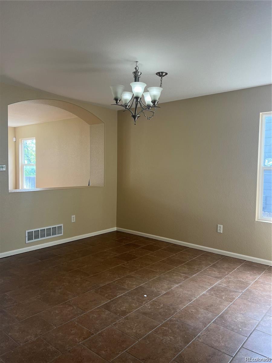 5353 Rhyolite Way Parker, CO 80134 - Photo 3 of 22 a view of wooden floor in an empty room with a window