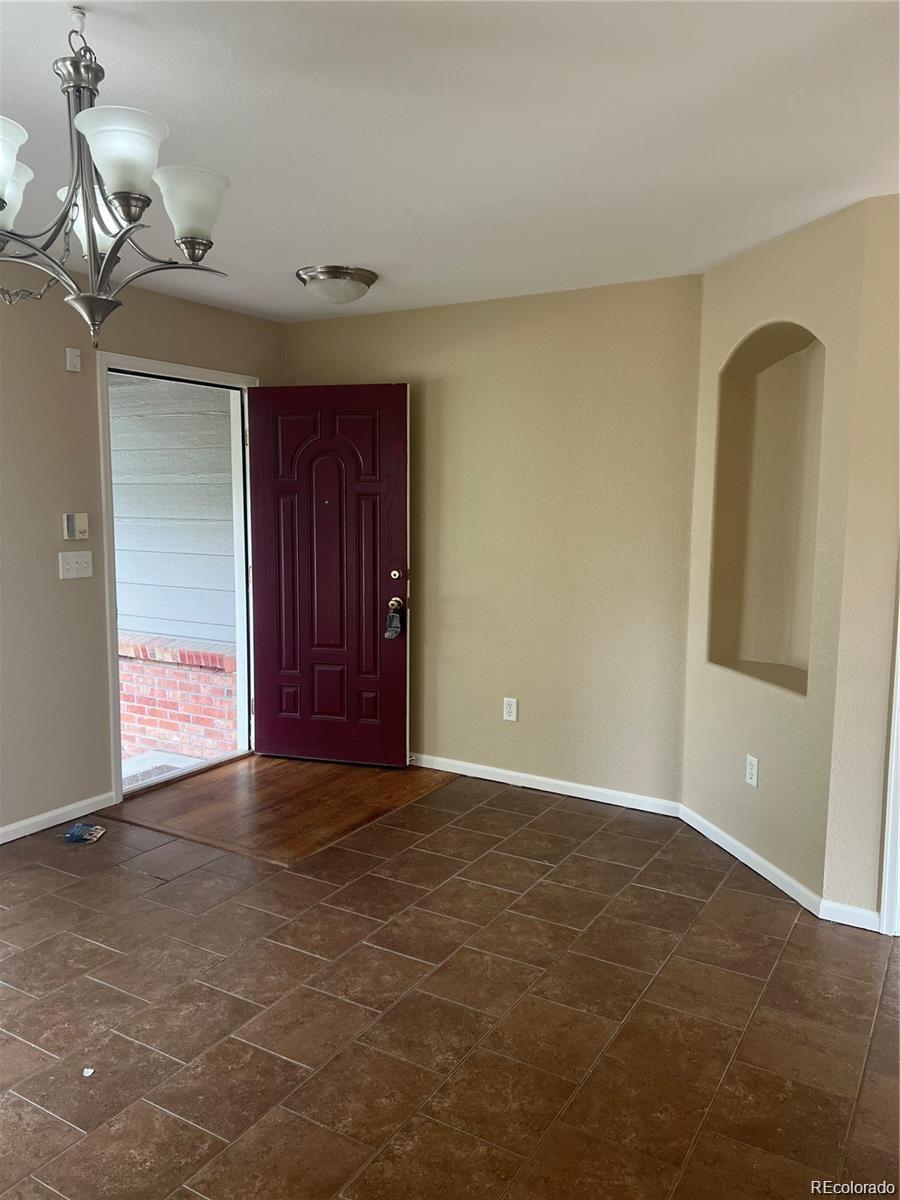 5353 Rhyolite Way Parker, CO 80134 - Photo 5 of 22 a view of an empty room with closet and wooden floor