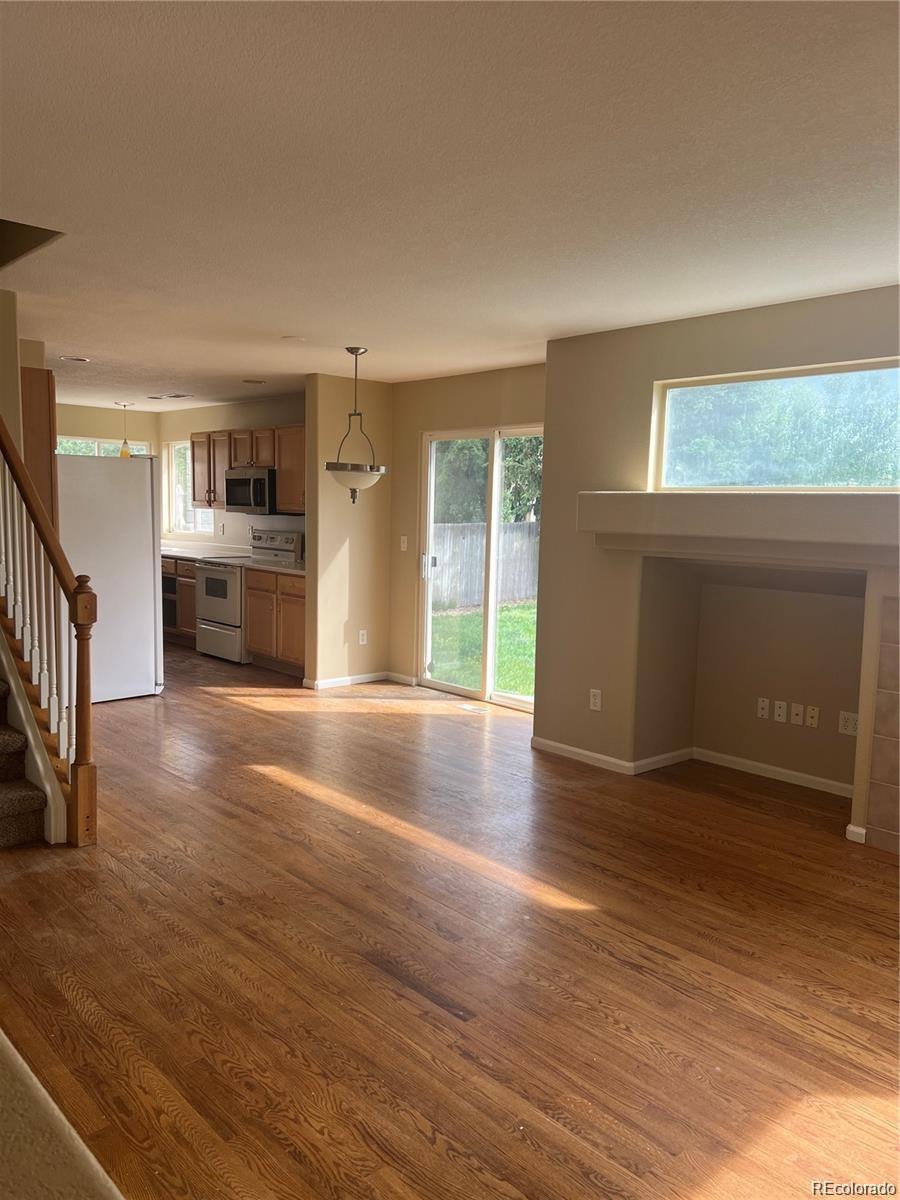 5353 Rhyolite Way Parker, CO 80134 - Photo 8 of 22 wooden floor in an empty room with a window