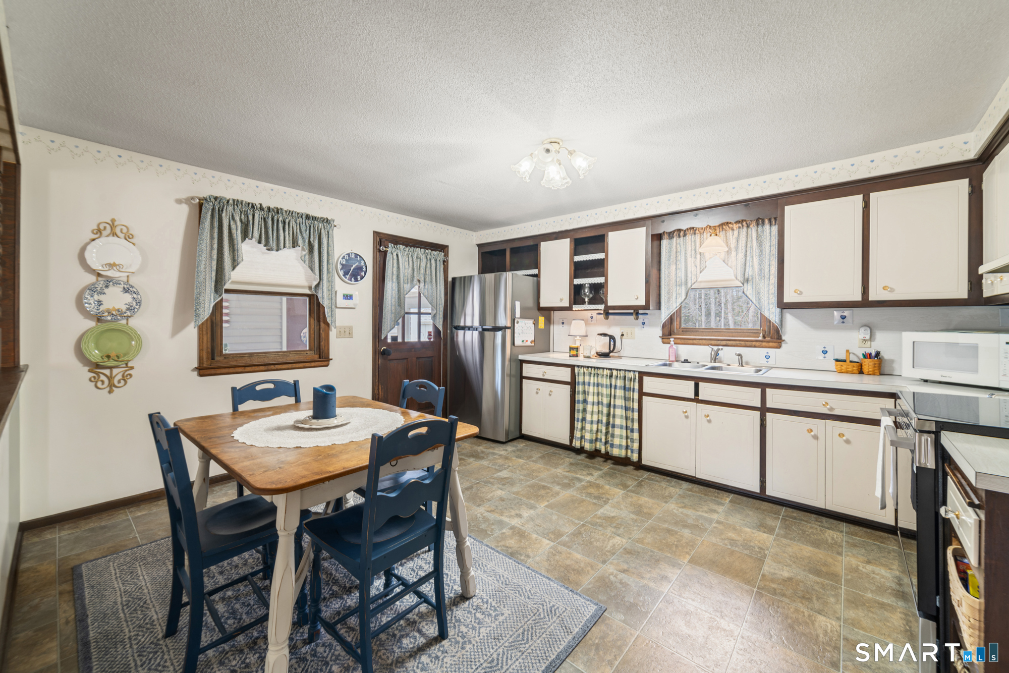 46 Buckboard Lane Bristol, CT 06010 - Photo 10 of 39 a kitchen with a table chairs sink and cabinets