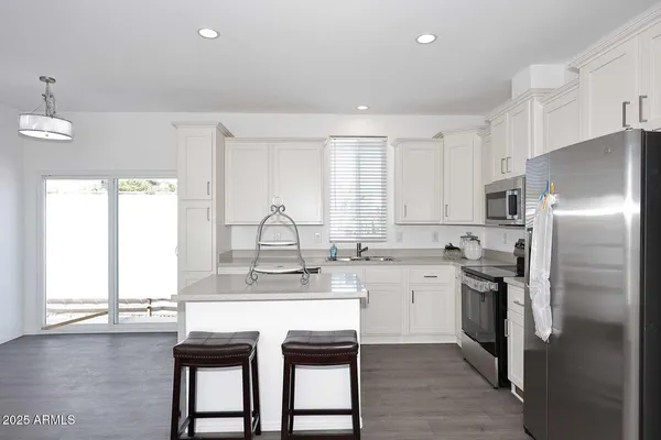 a kitchen with a sink a window and stainless steel appliances