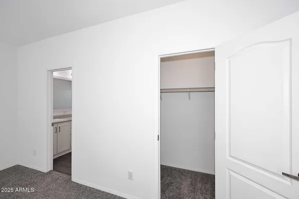 a view of walk in closet with white walls