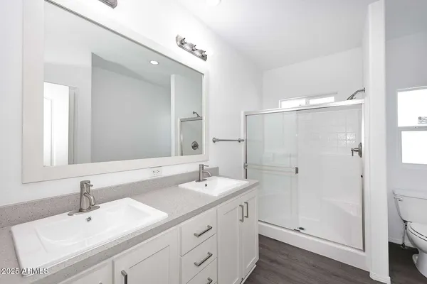 a bathroom with a sink double vanity and a mirror