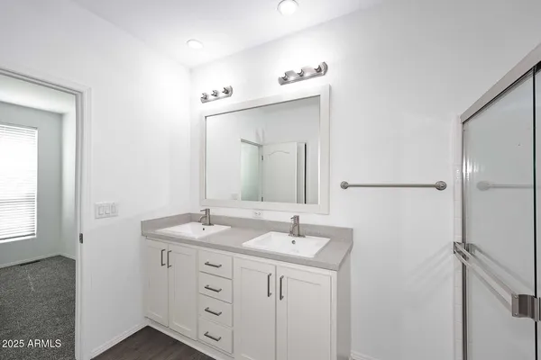 a bathroom with a sink vanity granite and a mirror
