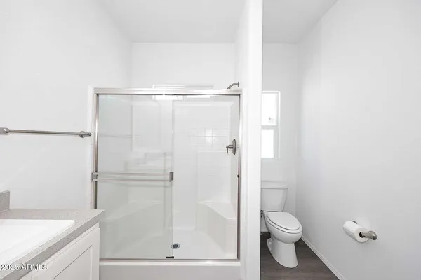 a bathroom with a shower a toilet and a sink