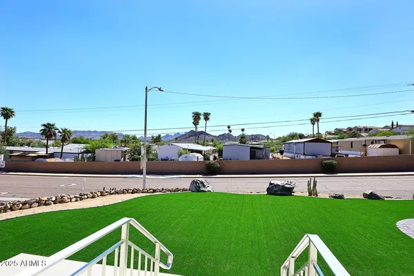 a view of yard with swimming pool and seating