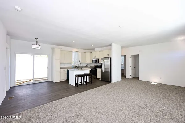 a view of kitchen with furniture and refrigerator
