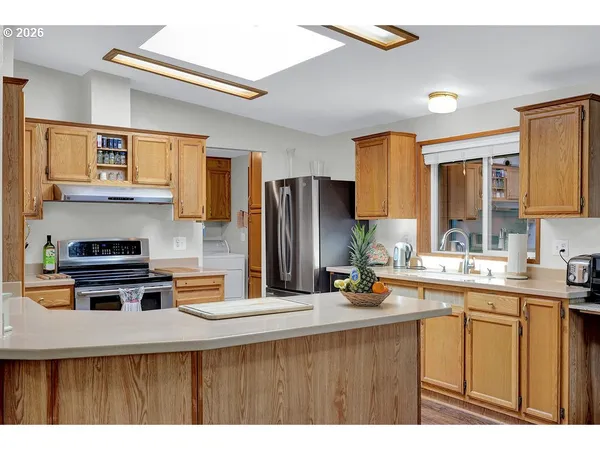 a kitchen with a sink a stove and cabinets