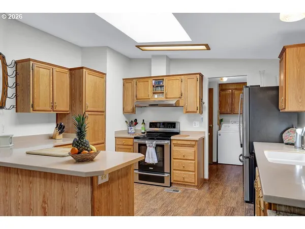 a kitchen with a stove a sink and a refrigerator