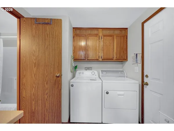 a kitchen that has a lot of cabinets a sink and a wooden floor in it