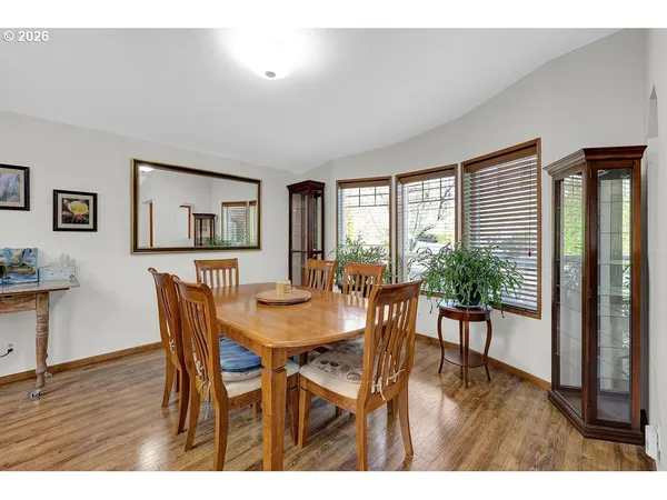 a view of a dining room with furniture and wooden floor
