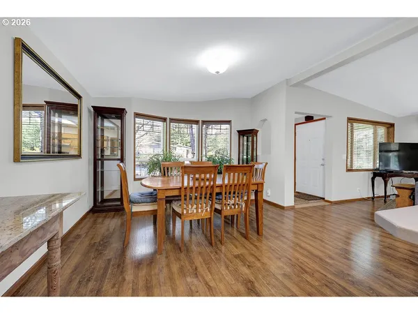 a dining room with furniture and wooden floor