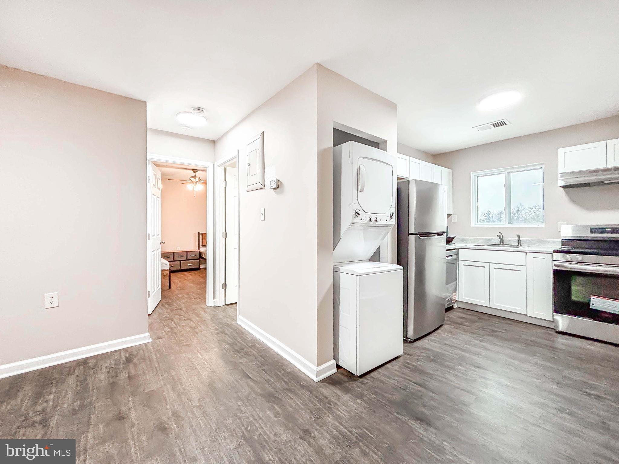 3924 Rolling Rd., Unit B11 Pikesville, MD 21208 - Photo 16 of 31 a kitchen with white cabinets and white appliances