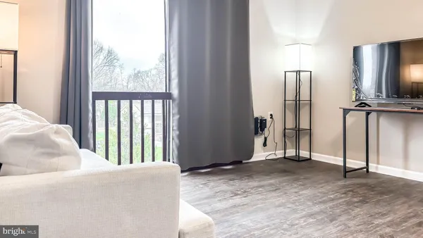 a view of an empty room and wooden floor