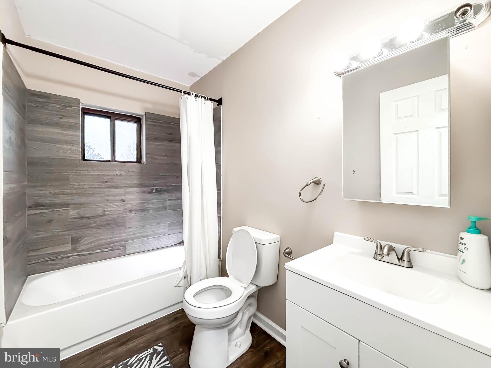 3924 Rolling Rd., Unit B11 Pikesville, MD 21208 - Photo 28 of 31 a bathroom with a sink toilet vanity and tub