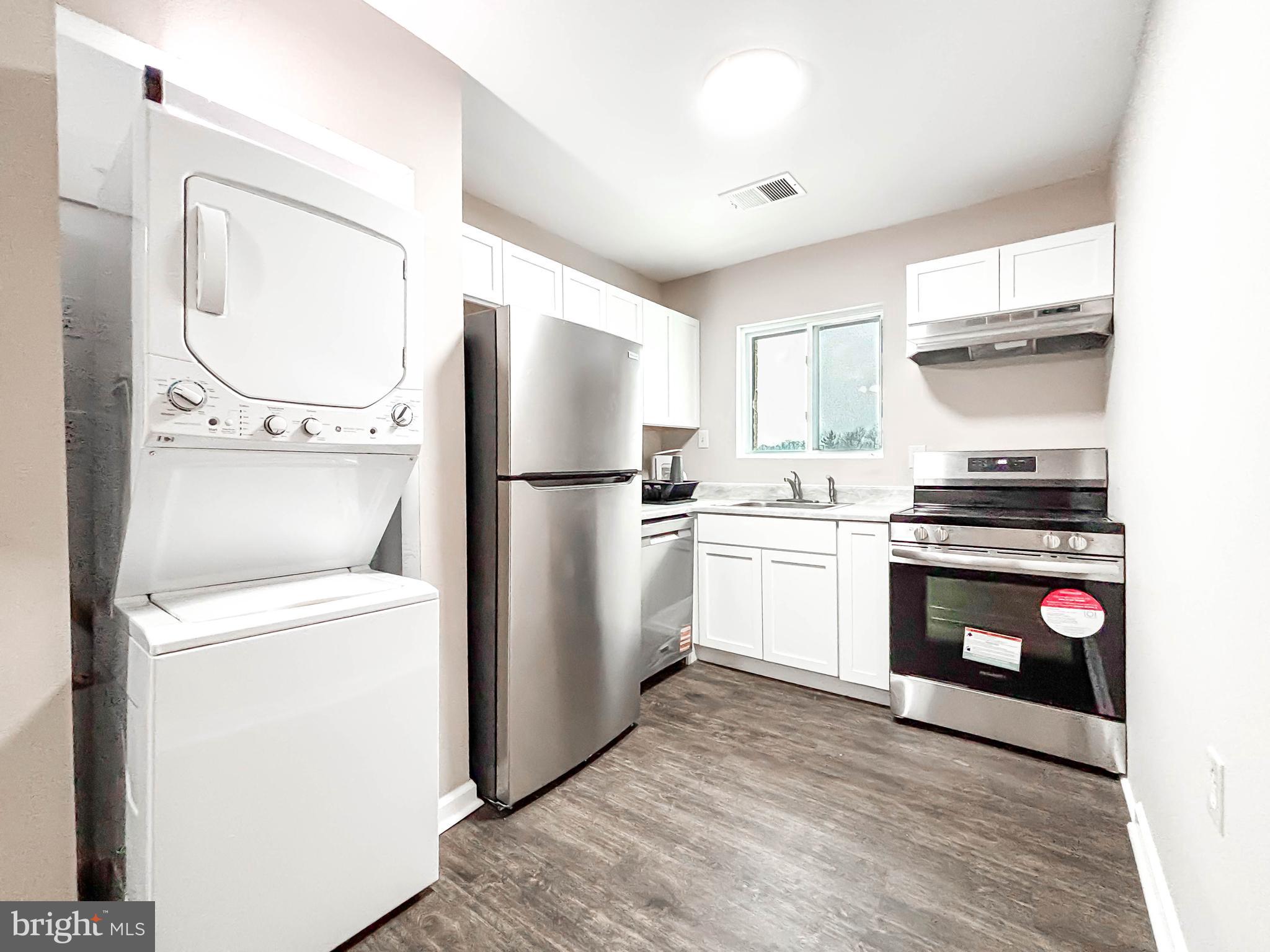 3924 Rolling Rd., Unit B11 Pikesville, MD 21208 - Photo 31 of 31 a kitchen with a refrigerator sink and cabinets