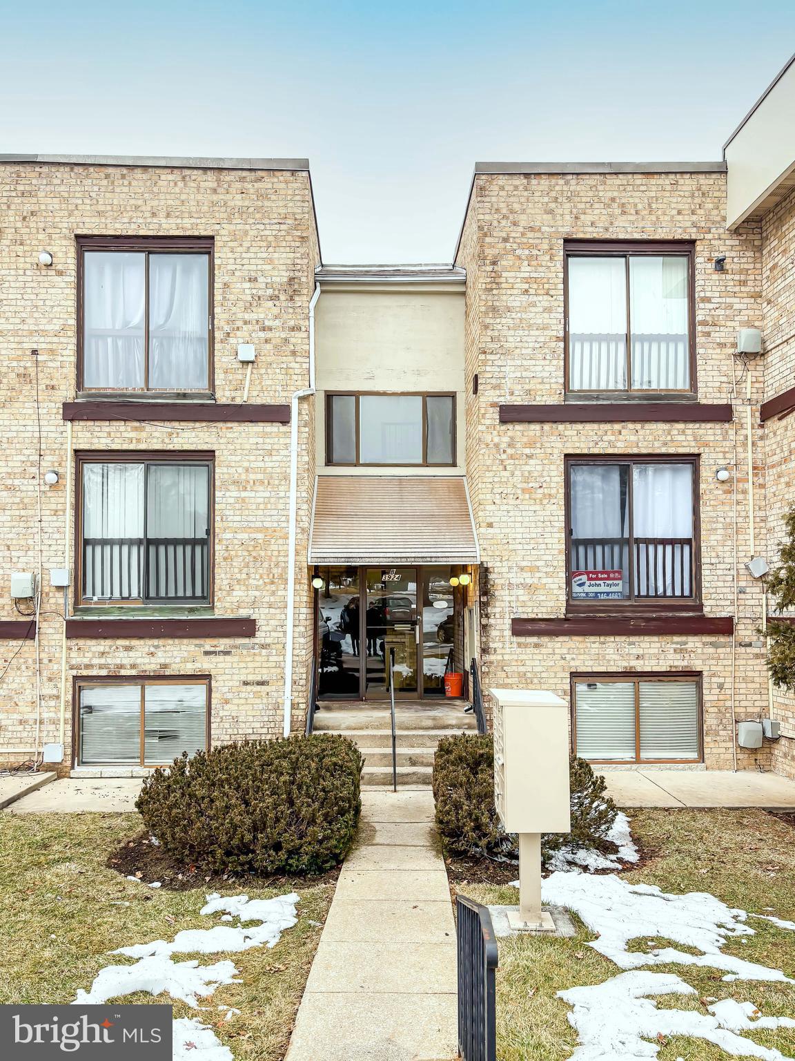 3924 Rolling Rd., Unit B11 Pikesville, MD 21208 - Photo 5 of 31 a living room with fireplace furniture and a kitchen view