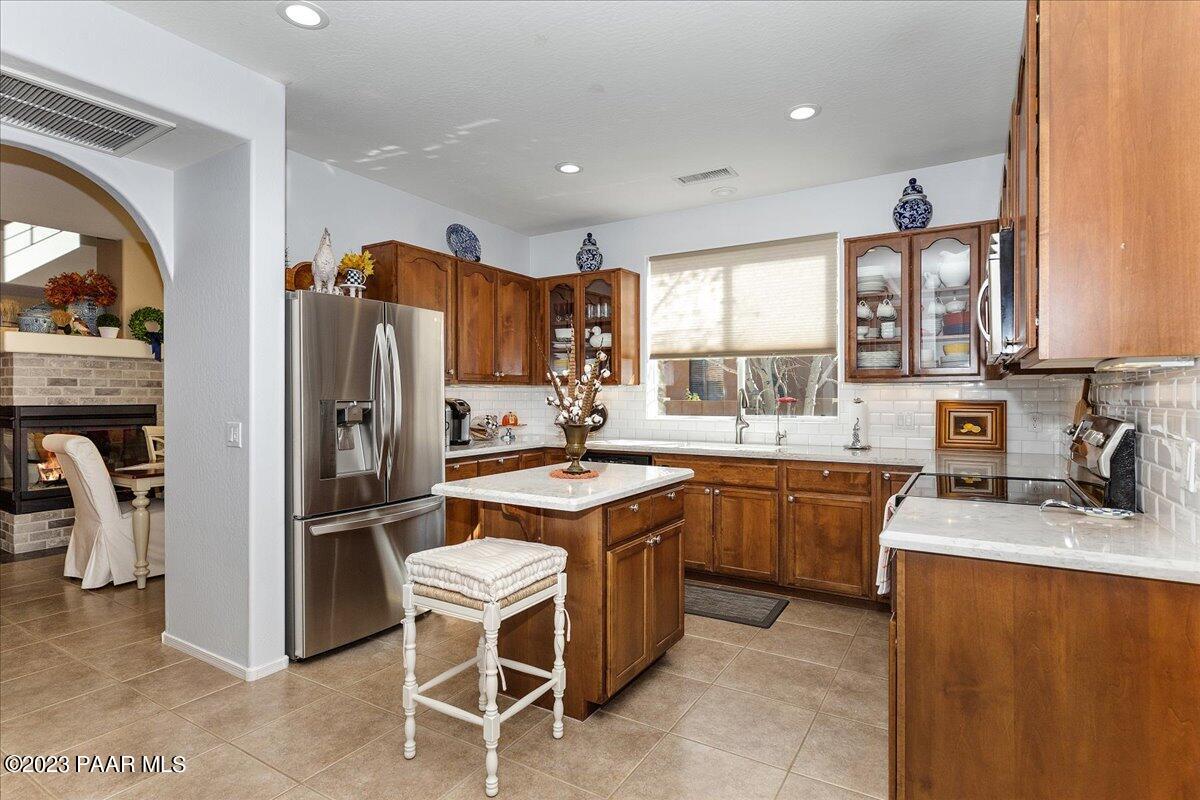 1908 North Fire Butte Way Prescott Valley, AZ 86314 - Photo 11 of 52 a kitchen with stainless steel appliances granite countertop a refrigerator a sink dishwasher a stove and a refrigerator