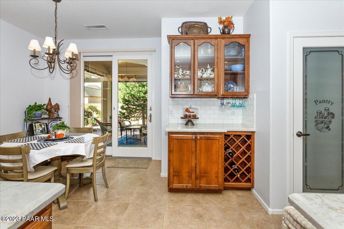 1908 North Fire Butte Way Prescott Valley, AZ 86314 - Photo 13 of 52 a dining room with chandelier and wooden floor