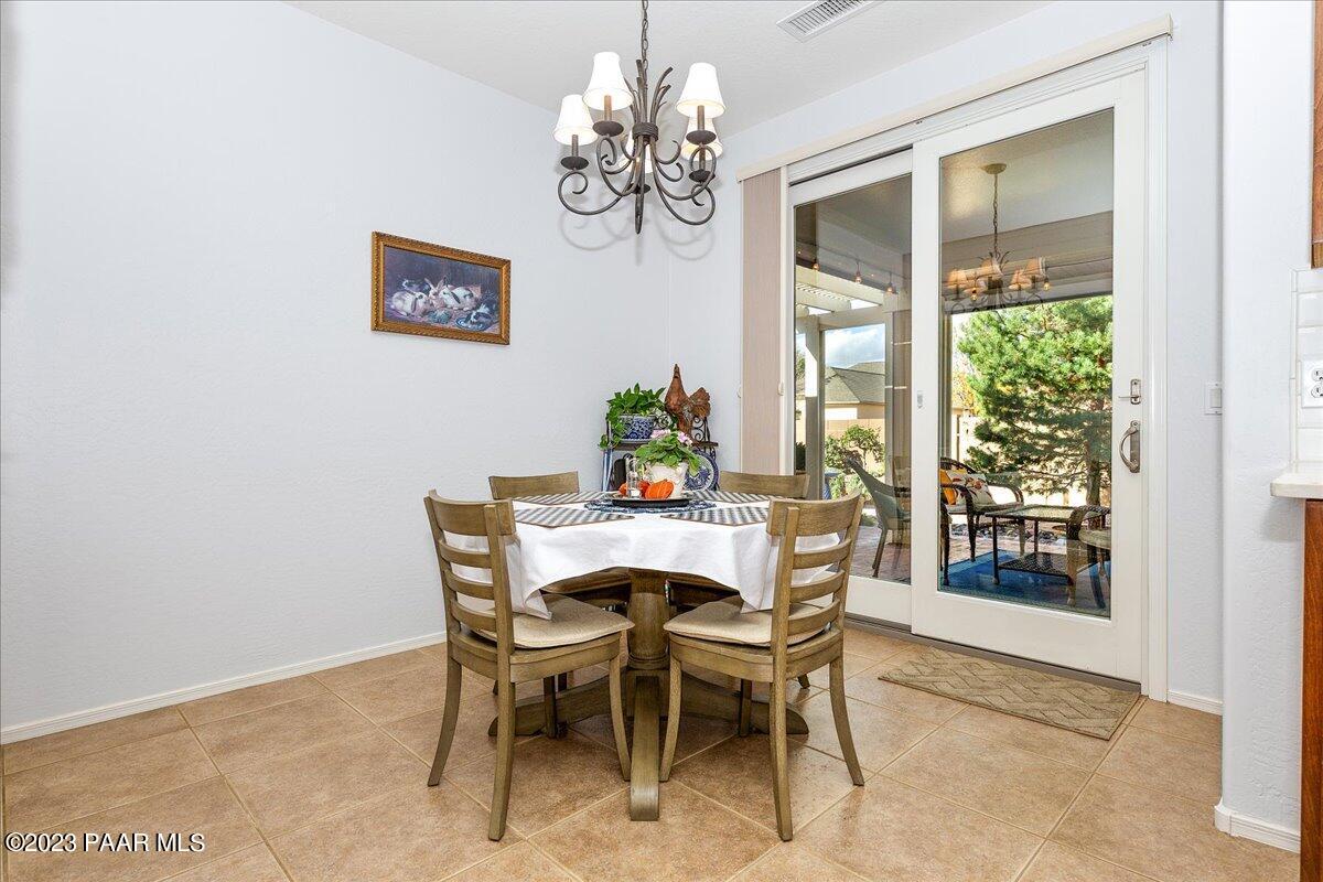 1908 North Fire Butte Way Prescott Valley, AZ 86314 - Photo 15 of 52 a dining room with furniture a large window and a chandelier