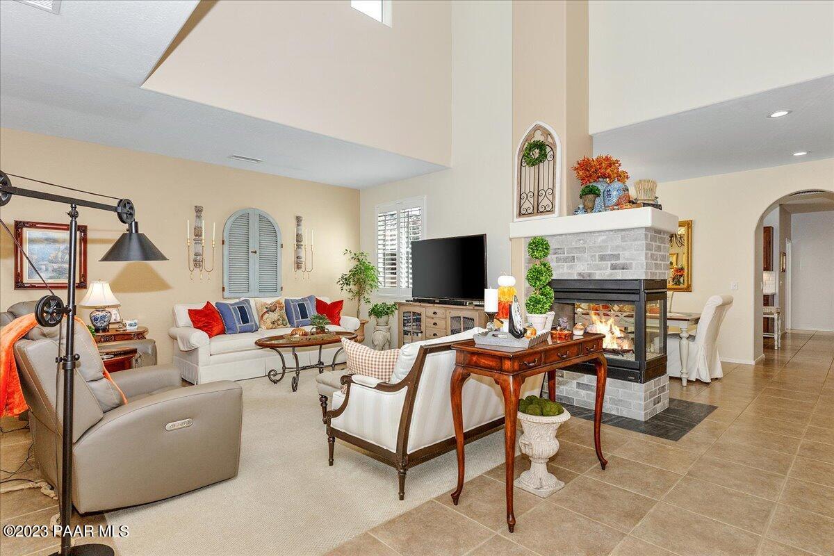 1908 North Fire Butte Way Prescott Valley, AZ 86314 - Photo 7 of 52 a living room with furniture a fireplace and a flat screen tv