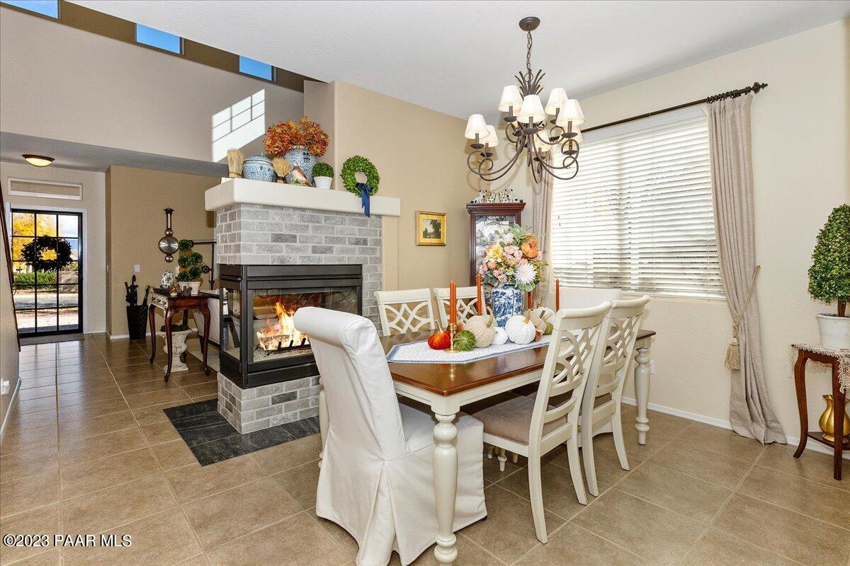 1908 North Fire Butte Way Prescott Valley, AZ 86314 - Photo 10 of 52 a dining room with furniture a fireplace and chandelier