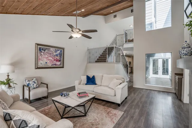 a living room with furniture a ceiling fan and a window
