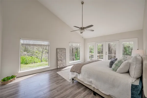 a large bedroom with a bed and a window