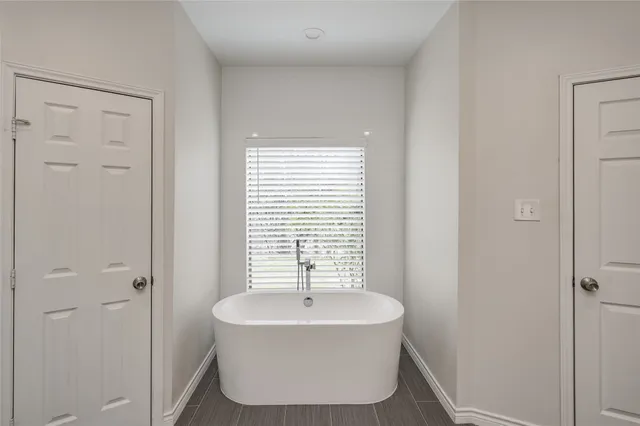 a bathroom with a bathtub and shower