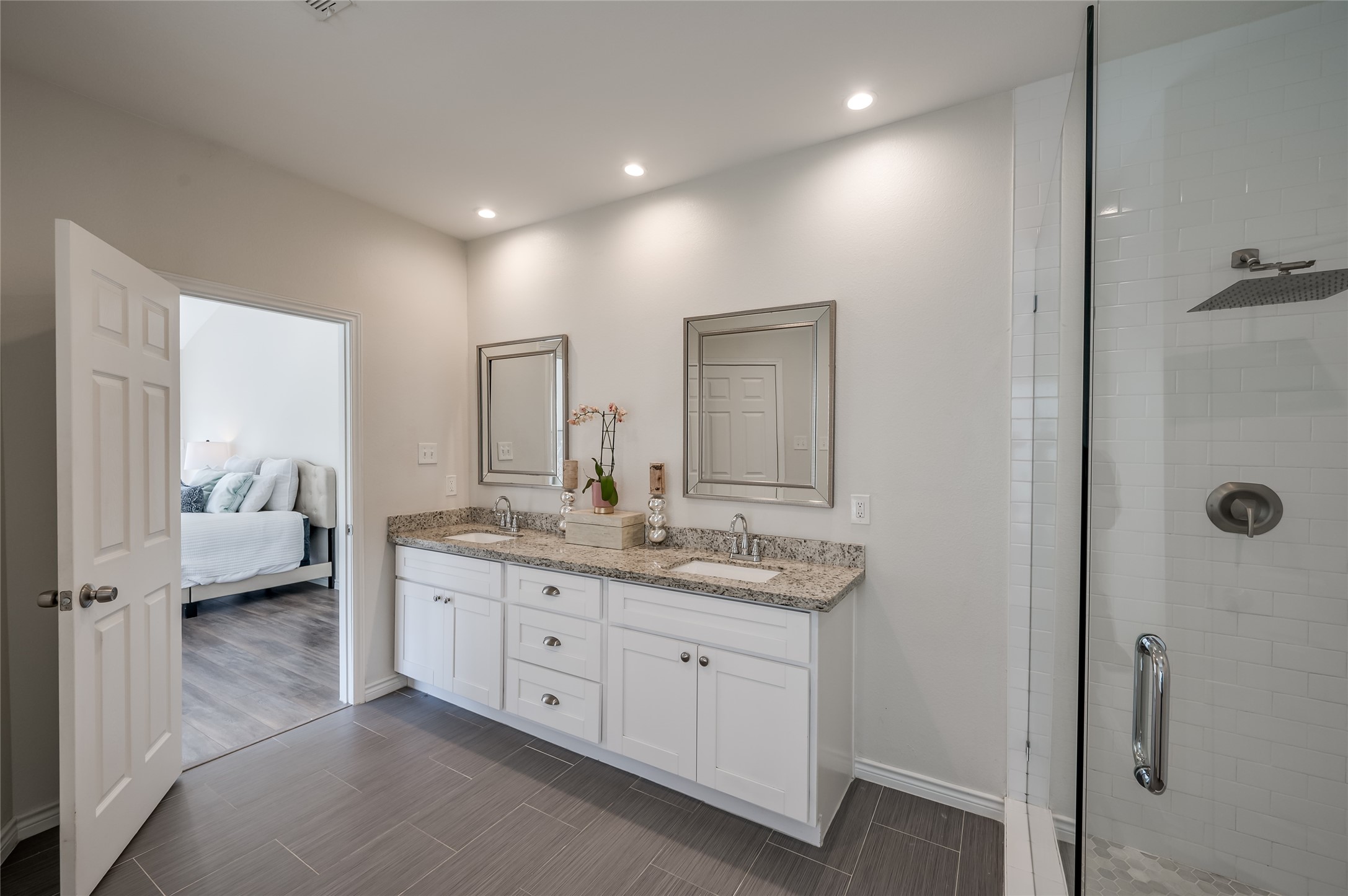 387 Rancho Bauer Drive Houston, TX 77079 - Photo 19 of 32 a en suite bathroom with a granite countertop sink and mirror