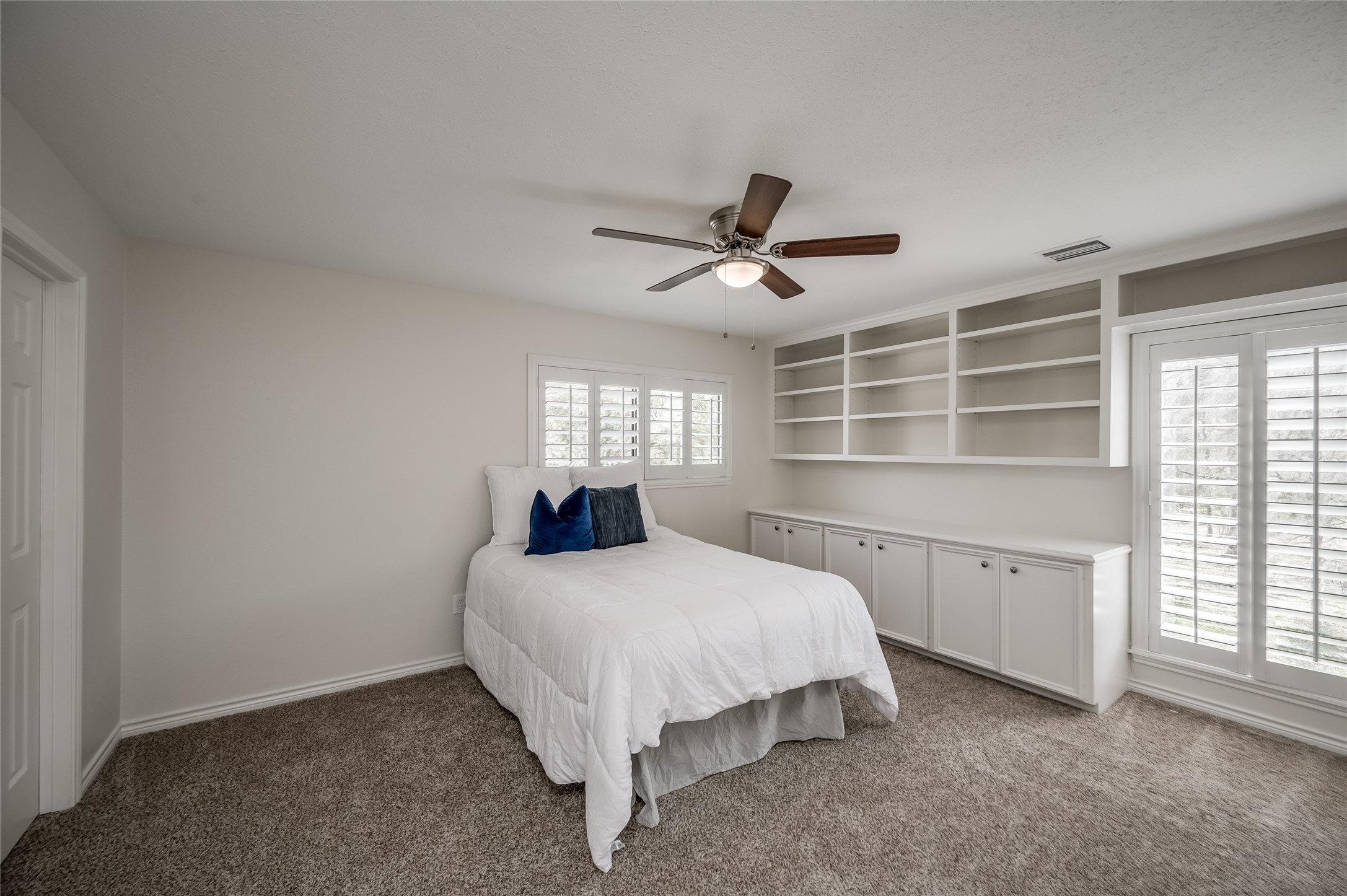 387 Rancho Bauer Drive Houston, TX 77079 - Photo 25 of 32 a spacious bedroom with a bed and a large window