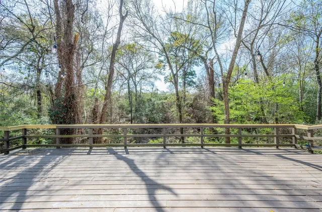a view of outdoor space with deck and large trees