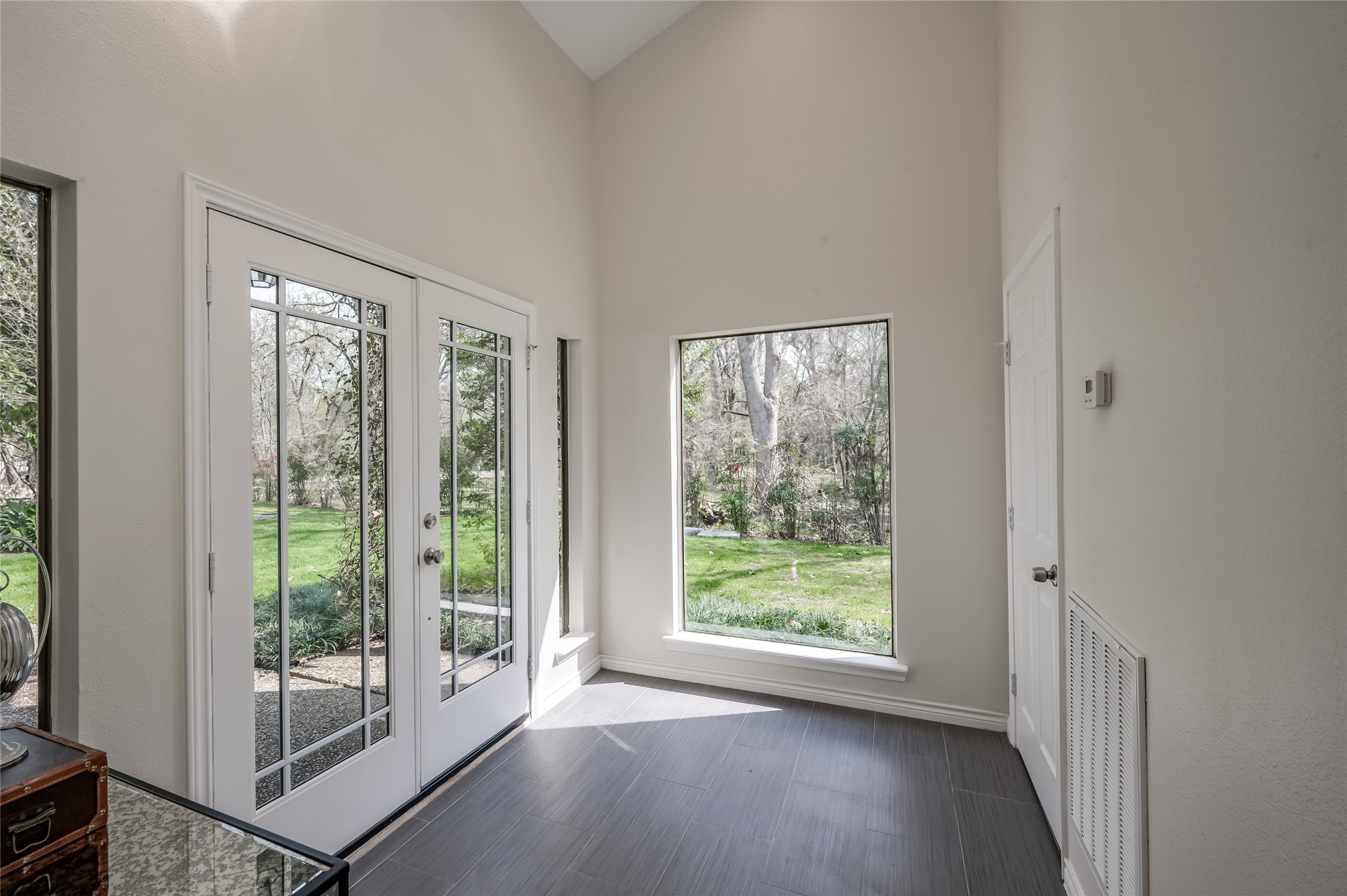 387 Rancho Bauer Drive Houston, TX 77079 - Photo 3 of 32 a view of an empty room with wooden floor and a window