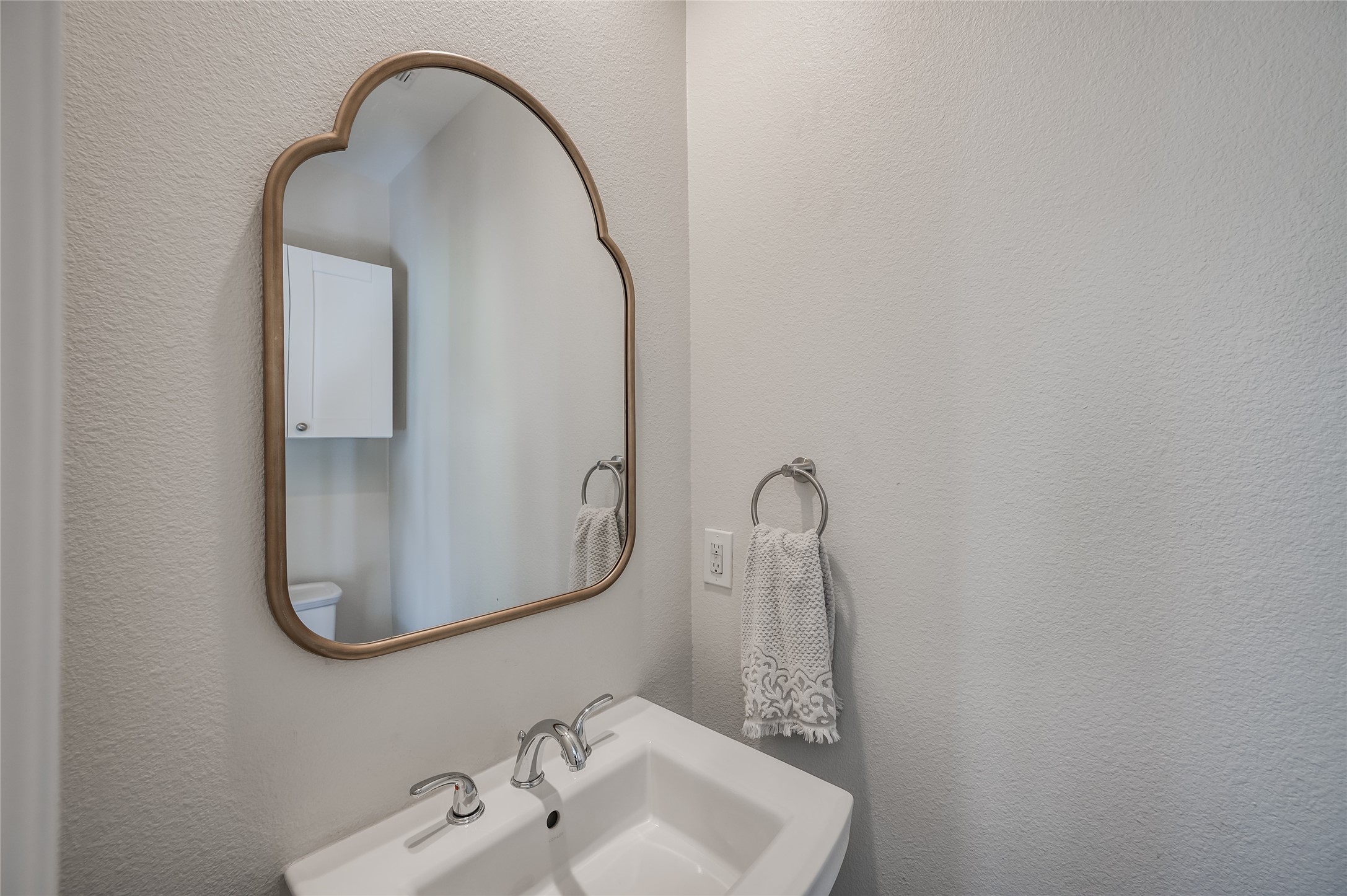 387 Rancho Bauer Drive Houston, TX 77079 - Photo 4 of 32 a close view of light fixtures and hallway with a sink