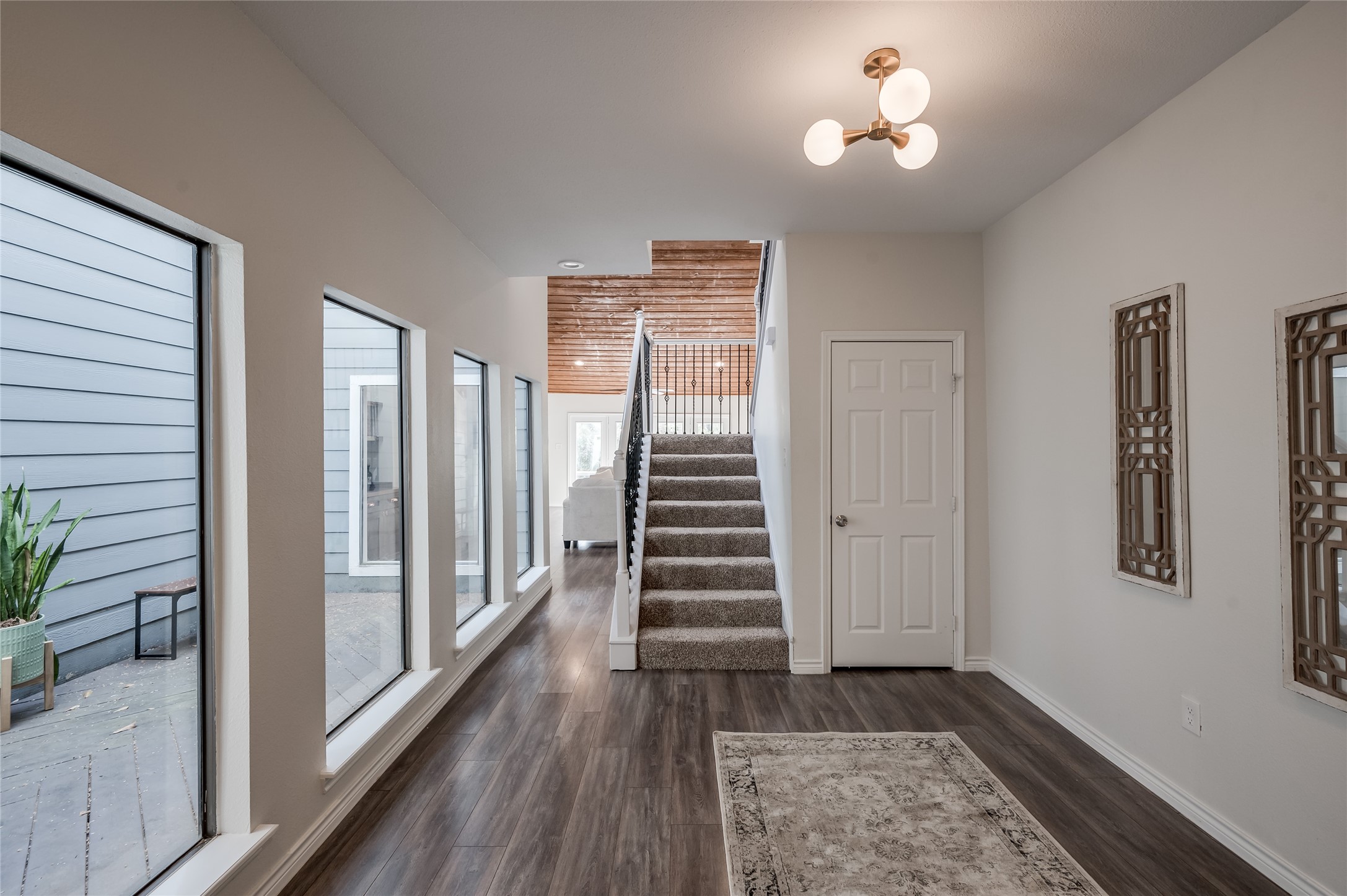 387 Rancho Bauer Drive Houston, TX 77079 - Photo 7 of 32 a view of a hallway with wooden floor and stairs