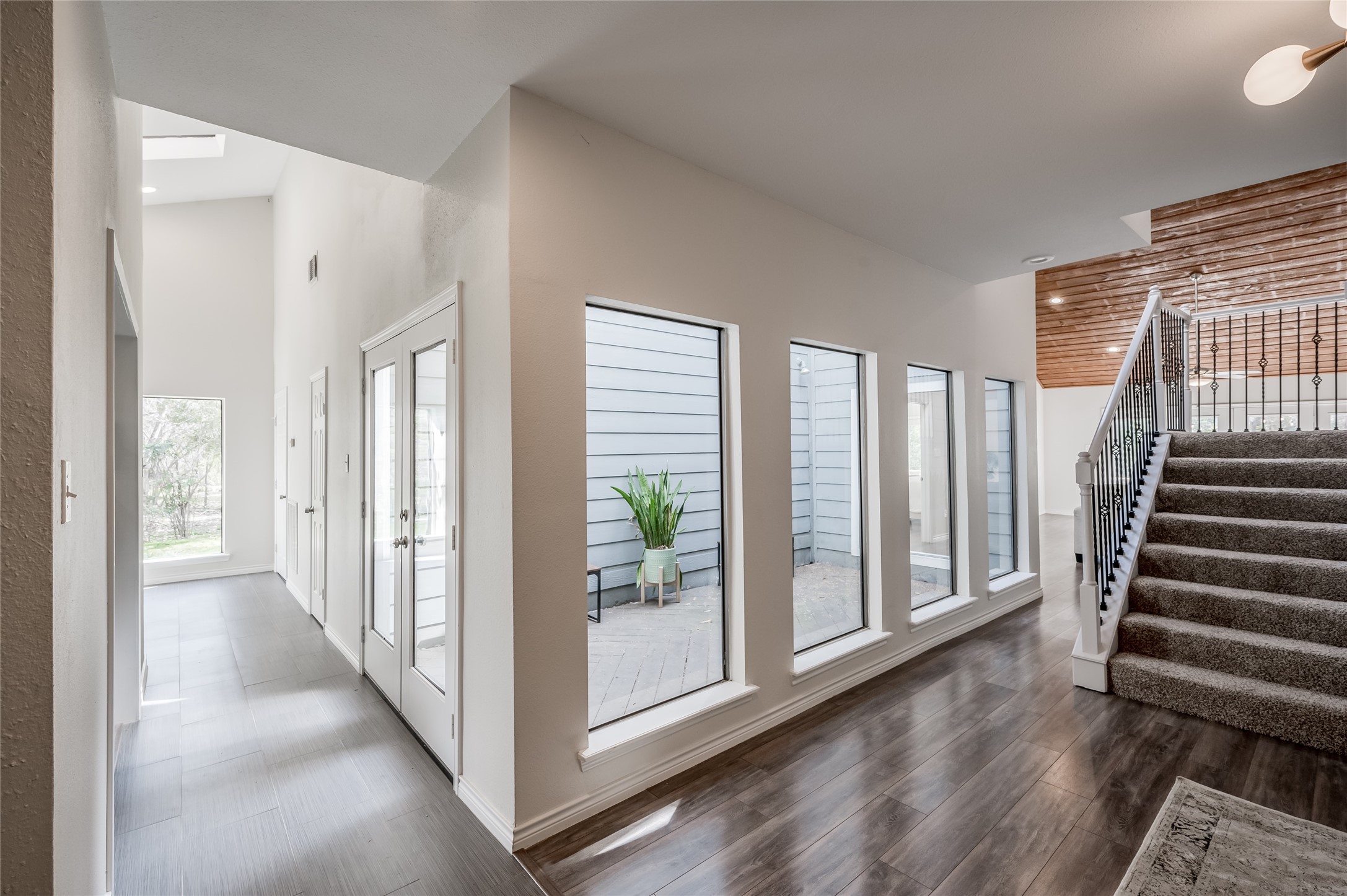 387 Rancho Bauer Drive Houston, TX 77079 - Photo 10 of 32 a view of a hallway with windows and stairs